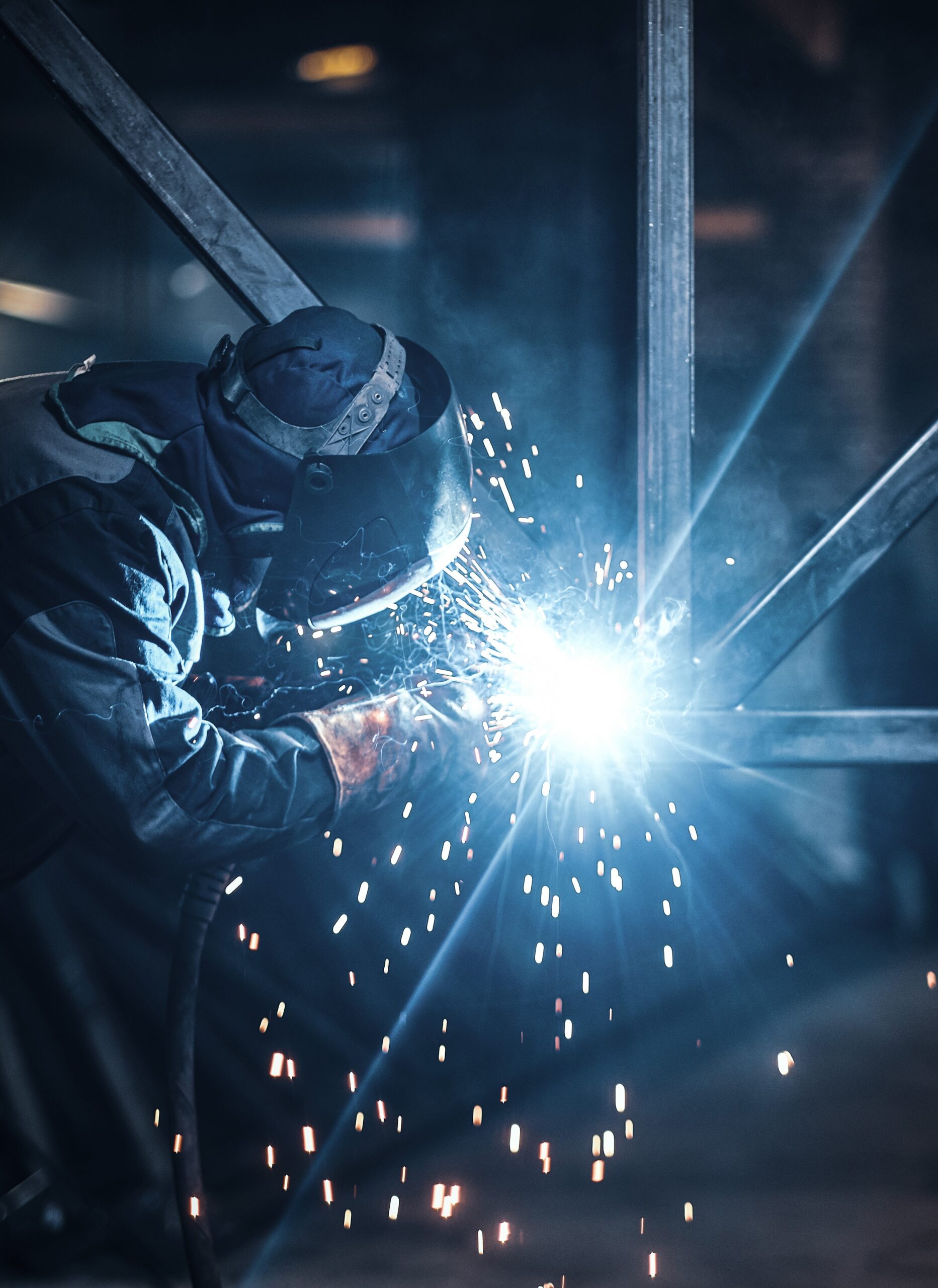 Welding work with metal construction at busy metal factory